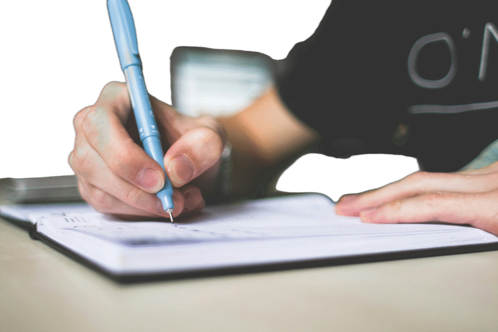 Handwriting on a blank notepad with a pen, suggesting clarity, planning, and creative thought.