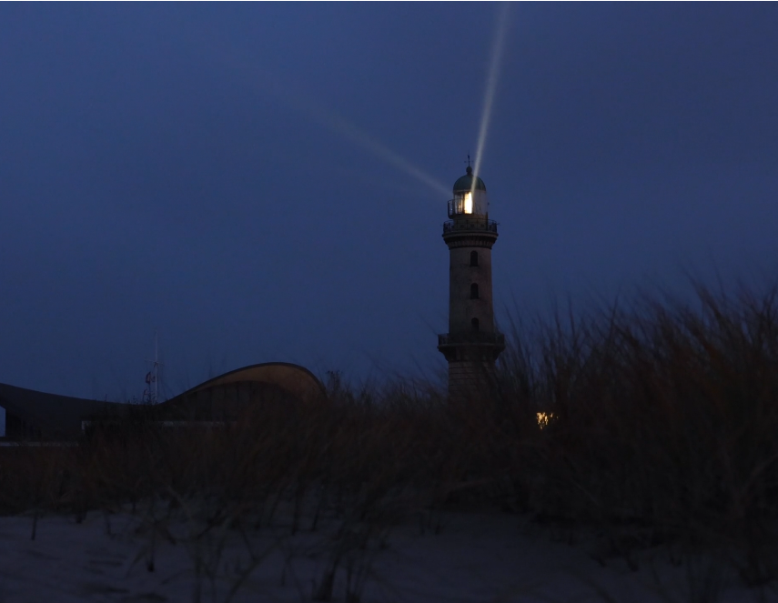 A lighthouse beacon cutting through the night sky, symbolizing clarity and guidance in the dark.