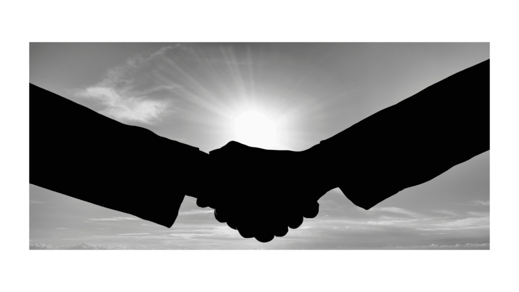 Silhouetted handshake against bright light, symbolizing a strong author–editor partnership.