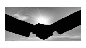 Silhouetted handshake against bright light, symbolizing a strong author–editor partnership.