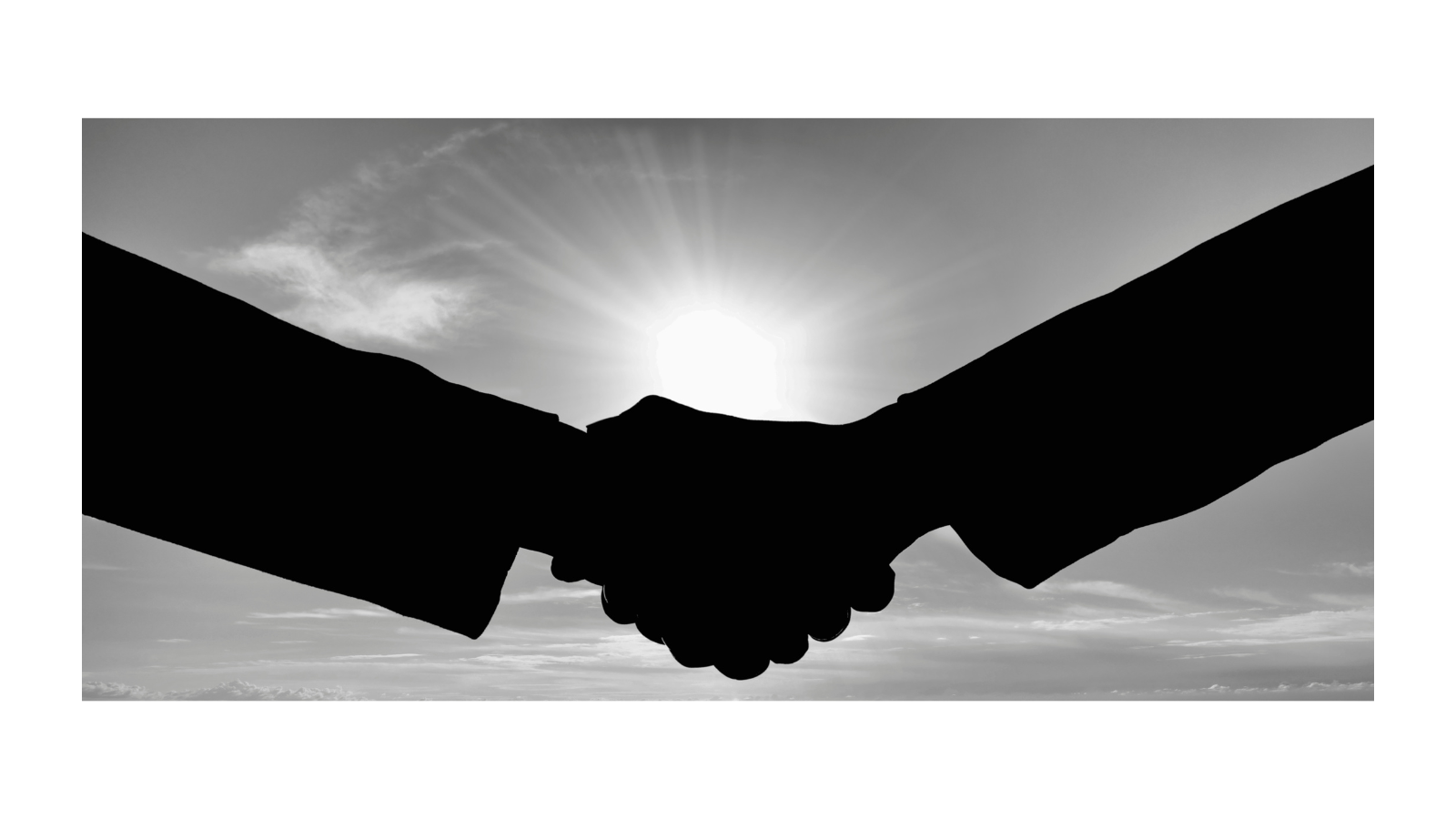 Silhouetted handshake against bright light, symbolizing a strong author–editor partnership.