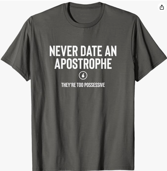 Dark gray t-shirt with the phrase “Never date an apostrophe. They’re possessive,” using grammar humor to spoof dating advice.