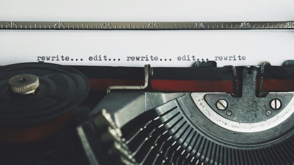 Vintage typewriter with the words “rewrite… edit… rewrite…” typed on the page.